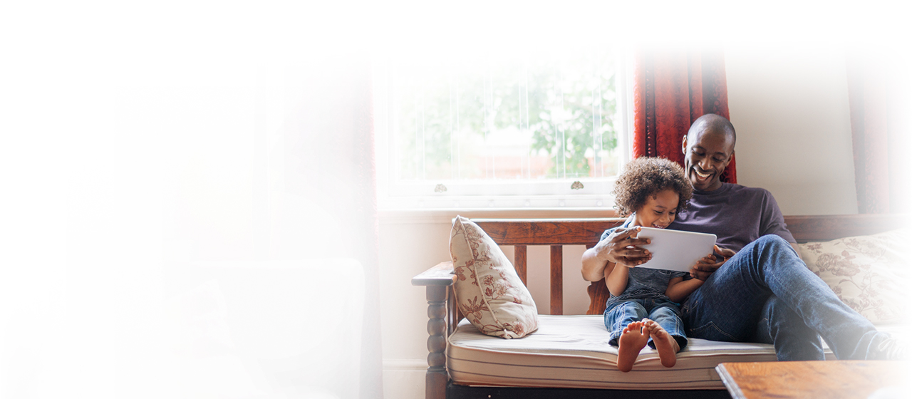 Man reading to child on couch